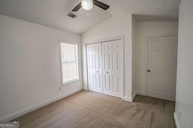107 Griffith St, Winder, GA 30680 - unfurnished bedroom featuring visible vents, a closet, baseboards, carpet, and vaulted ceiling
