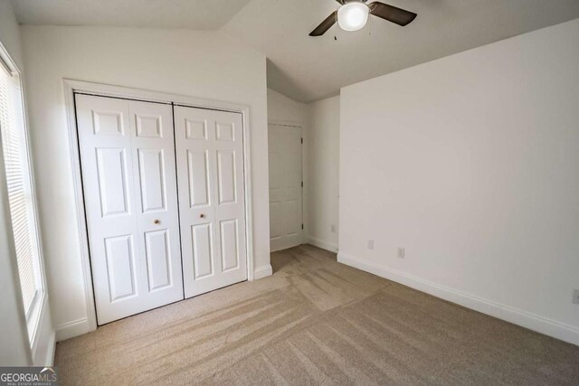 107 Griffith St, Winder, GA 30680 - unfurnished bedroom with carpet floors, a closet, lofted ceiling, baseboards, and a ceiling fan
