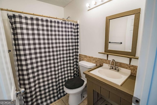107 Griffith St, Winder, GA 30680 - bathroom with vanity, toilet, tile patterned floors, a shower with shower curtain, and tile walls