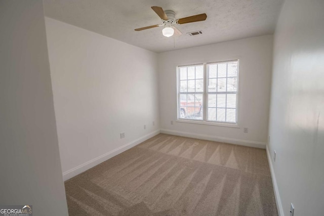 107 Griffith St, Winder, GA 30680 - spare room with baseboards, ceiling fan, light carpet, and visible vents