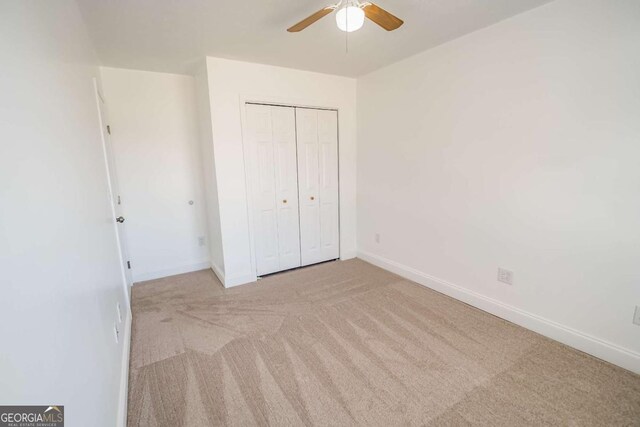 107 Griffith St, Winder, GA 30680 - unfurnished bedroom with carpet floors, baseboards, a ceiling fan, and a closet