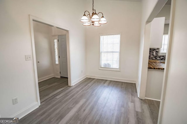 107 Griffith St, Winder, GA 30680 - unfurnished dining area featuring baseboards, dark wood-style flooring, and a chandelier