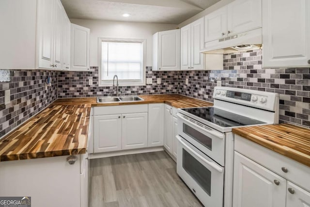 107 Griffith St, Winder, GA 30680 - kitchen featuring white cabinets, a sink, wooden counters, double oven range, and under cabinet range hood
