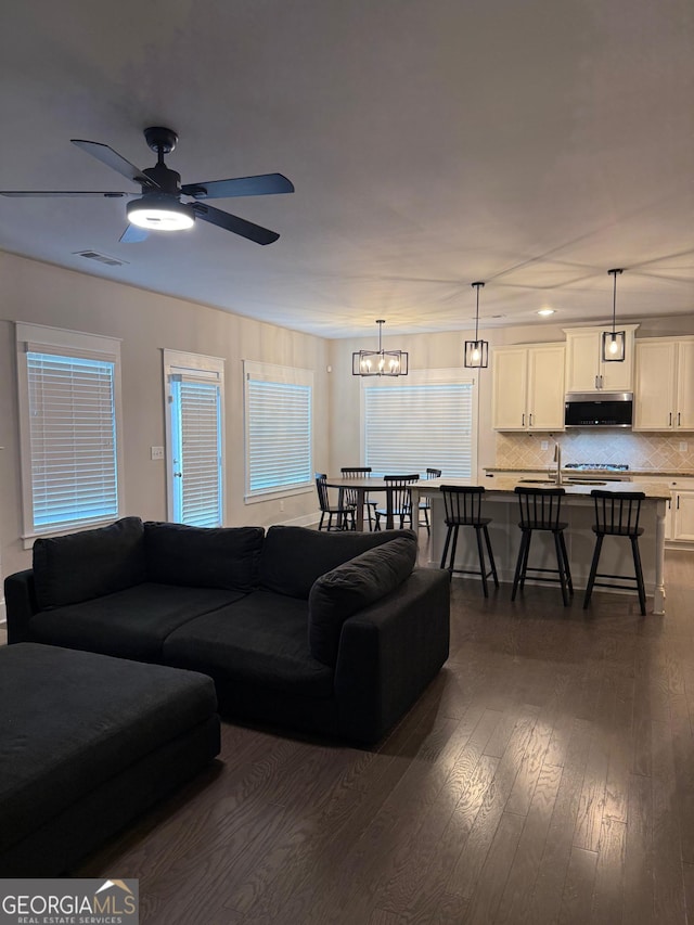 2470 Wevok Way, Grayson, GA 30017 - living room with ceiling fan with notable chandelier, dark wood-style floors, and visible vents