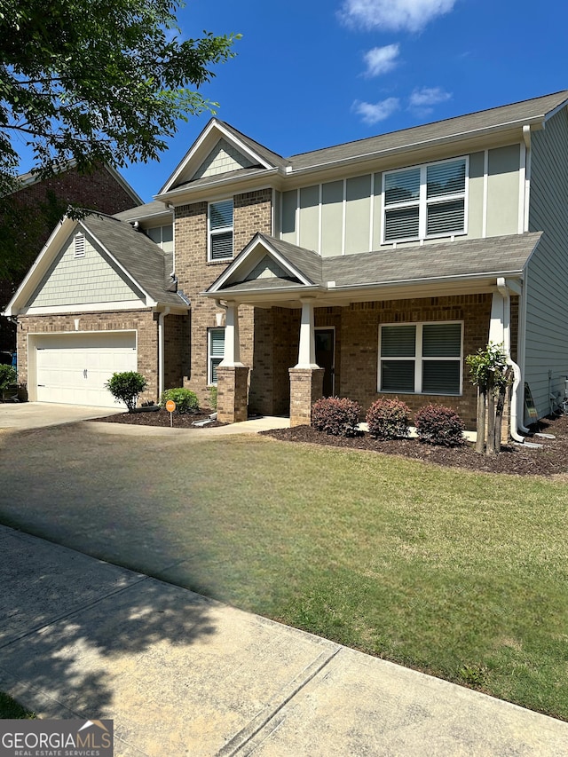 2470 Wevok Way, Grayson, GA 30017 - view of front of house with a garage, driveway, brick siding, and a front yard