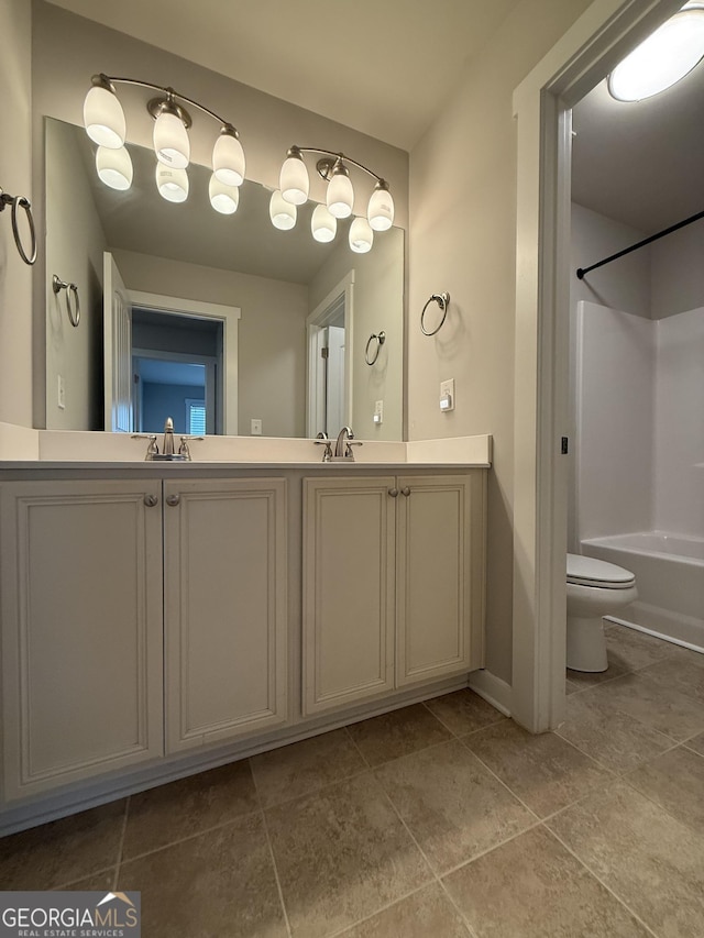 2470 Wevok Way, Grayson, GA 30017 - bathroom with double vanity, bathing tub / shower combination, tile patterned flooring, and toilet