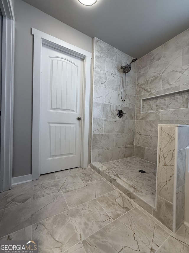 2470 Wevok Way, Grayson, GA 30017 - bathroom with baseboards, marble finish floor, and tiled shower