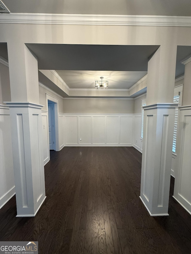 2470 Wevok Way, Grayson, GA 30017 - unfurnished dining area featuring crown molding, dark wood-style flooring, a decorative wall, and wainscoting