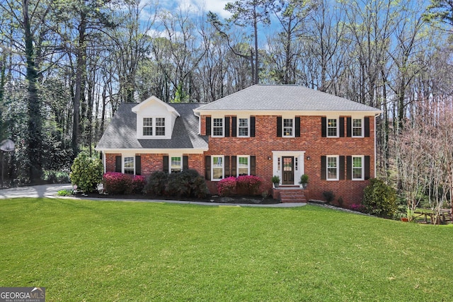 1135 Parkview Way, Lilburn, GA 30047 - colonial house with a front yard and brick siding