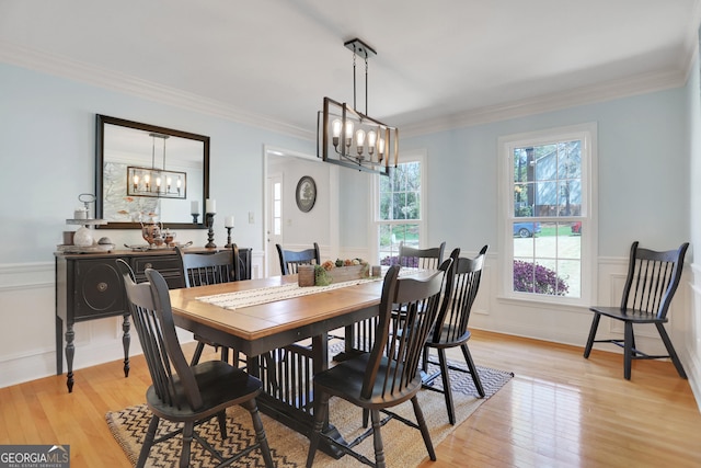 1135 Parkview Way, Lilburn, GA 30047 - dining area with crown molding, light wood finished floors, and a notable chandelier