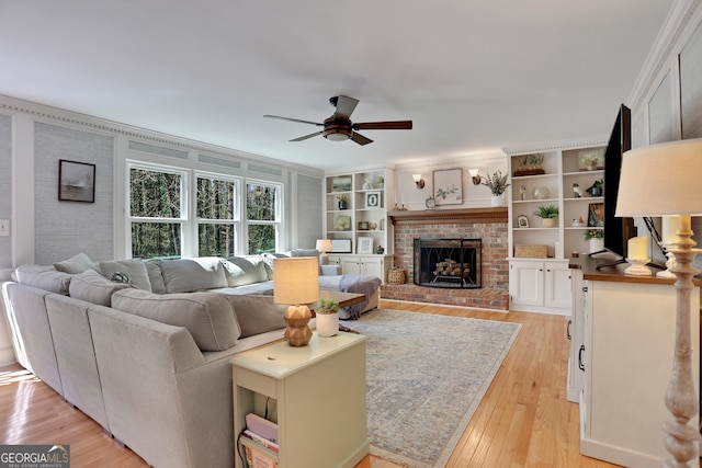 1135 Parkview Way, Lilburn, GA 30047 - living room featuring a ceiling fan, light wood-style floors, crown molding, and a fireplace
