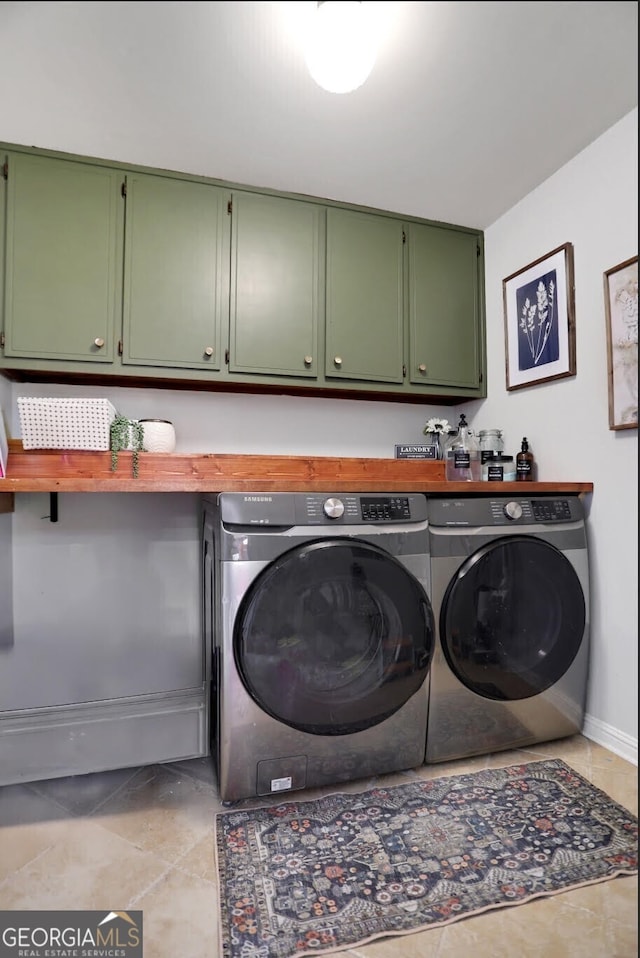 1135 Parkview Way, Lilburn, GA 30047 - laundry room featuring light tile patterned floors, cabinet space, washing machine and clothes dryer, and baseboards