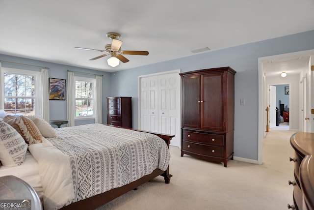 1135 Parkview Way, Lilburn, GA 30047 - bedroom featuring a closet, light carpet, baseboards, visible vents, and a ceiling fan