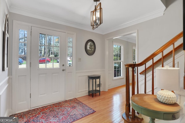 1135 Parkview Way, Lilburn, GA 30047 - foyer featuring stairway, ornamental molding, light wood-style floors, and a decorative wall