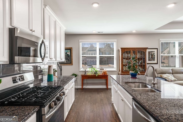 2910 Bishopstone Way, Cumming, GA 30040 - kitchen with baseboards, white cabinetry, a sink, and appliances with stainless steel finishes