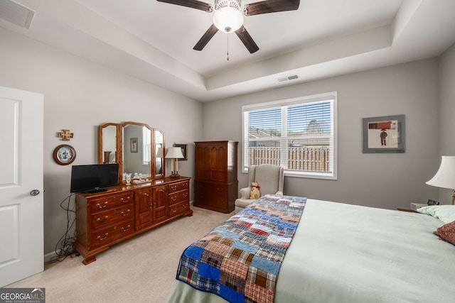 2910 Bishopstone Way, Cumming, GA 30040 - bedroom featuring a tray ceiling, light colored carpet, ceiling fan, and visible vents