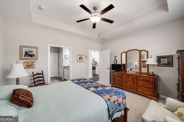 2910 Bishopstone Way, Cumming, GA 30040 - bedroom featuring ensuite bathroom, baseboards, ceiling fan, a tray ceiling, and light carpet
