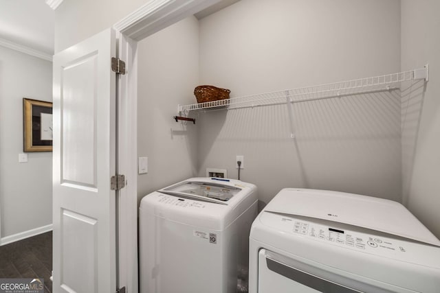 2910 Bishopstone Way, Cumming, GA 30040 - clothes washing area featuring baseboards, dark wood-style flooring, ornamental molding, laundry area, and washing machine and clothes dryer
