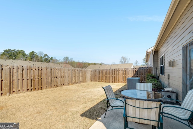 2910 Bishopstone Way, Cumming, GA 30040 - view of yard featuring central AC unit, a fenced backyard, a patio, and outdoor dining area