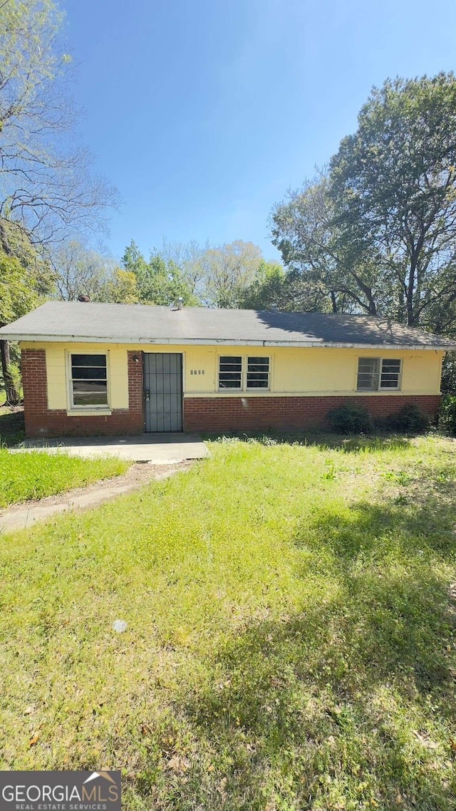 ranch-style house with a front lawn and brick siding
