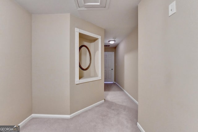 corridor featuring carpet, baseboards, and visible vents
