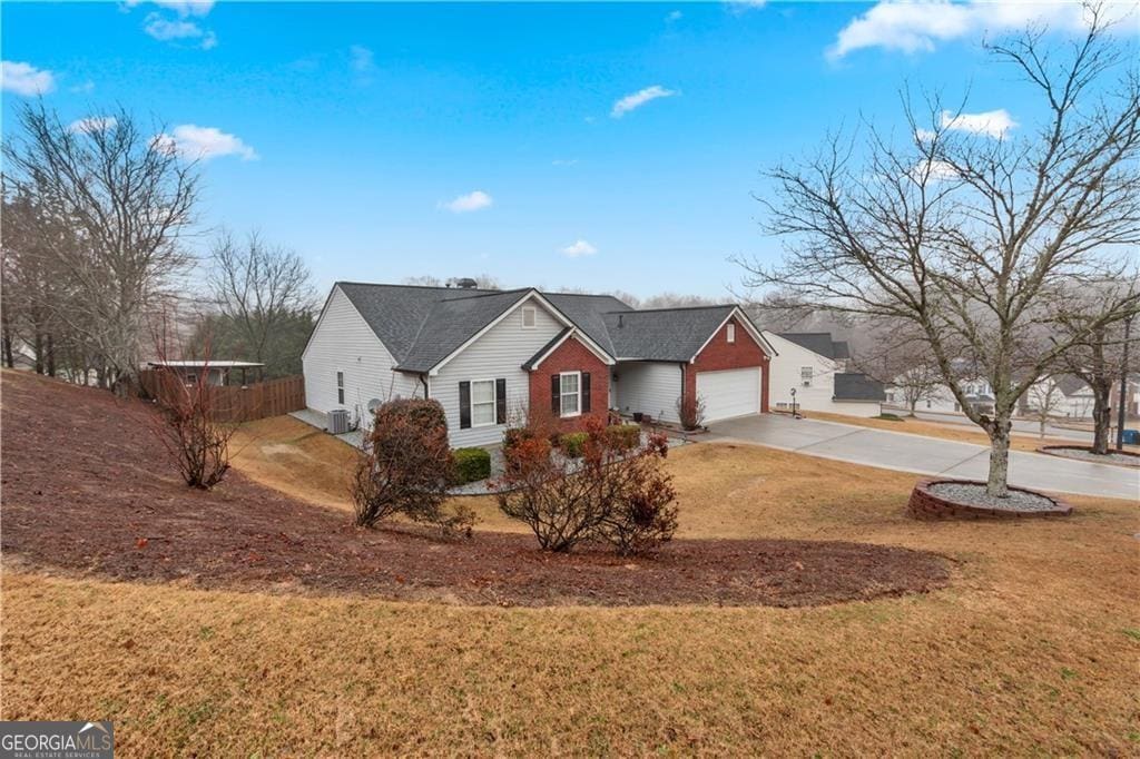1760 Campbell Ives Dr, Lawrenceville, GA 30045 - ranch-style home with a garage, driveway, a front lawn, and fence
