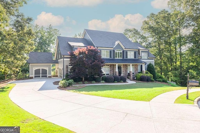1521 Waterside Ct, Jefferson, GA 30549 - view of front facade with driveway, a garage, a front yard, an outbuilding, and a standing seam roof