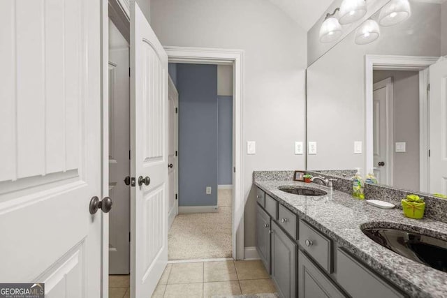 1521 Waterside Ct, Jefferson, GA 30549 - bathroom with double vanity, tile patterned flooring, baseboards, and vaulted ceiling