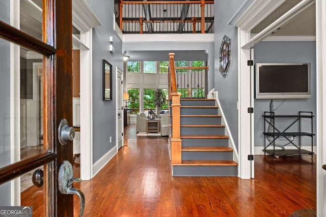 1521 Waterside Ct, Jefferson, GA 30549 - foyer with baseboards, wood finished floors, stairs, a high ceiling, and ornamental molding