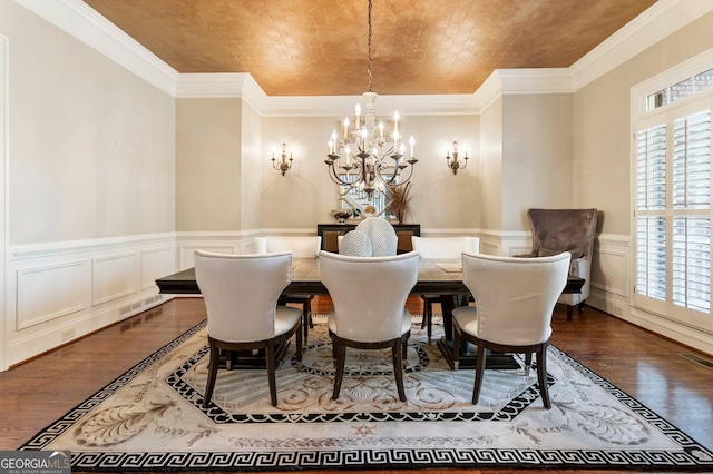 150 Inwood Ter, Roswell, GA 30075 - dining room with visible vents, a notable chandelier, crown molding, wainscoting, and wood finished floors