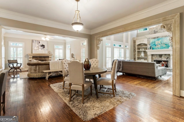 150 Inwood Ter, Roswell, GA 30075 - dining room with dark wood-style flooring, crown molding, and a lit fireplace