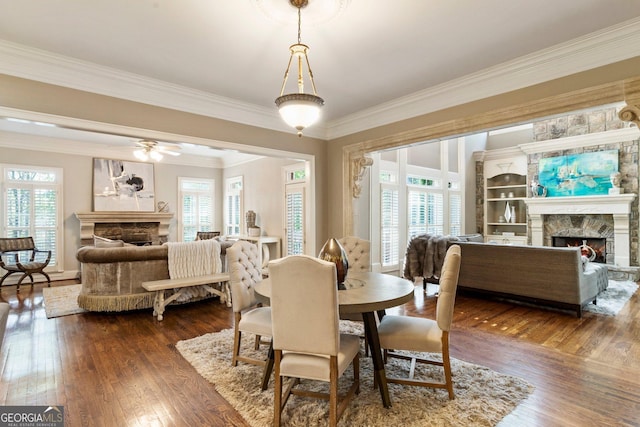 150 Inwood Ter, Roswell, GA 30075 - dining room with dark wood-style floors, a stone fireplace, crown molding, and ceiling fan