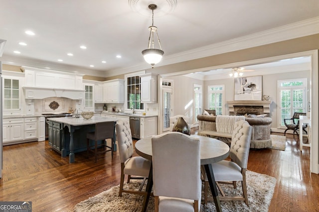 150 Inwood Ter, Roswell, GA 30075 - dining room featuring a fireplace, recessed lighting, dark wood-style flooring, and crown molding