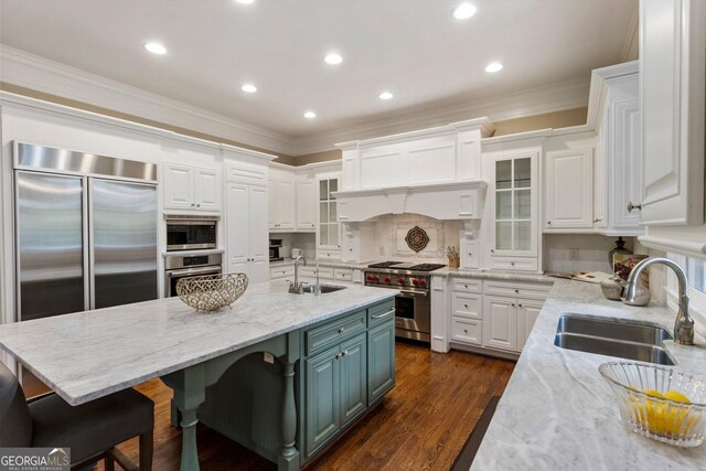 150 Inwood Ter, Roswell, GA 30075 - kitchen featuring crown molding, built in appliances, a sink, and white cabinetry