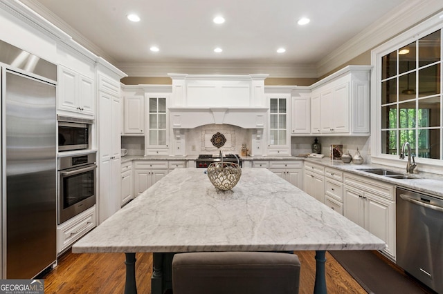 150 Inwood Ter, Roswell, GA 30075 - kitchen with white cabinets, built in appliances, a kitchen bar, and a sink