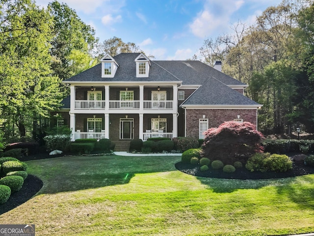 150 Inwood Ter, Roswell, GA 30075 - neoclassical / greek revival house featuring a balcony, a chimney, a front yard, brick siding, and a shingled roof
