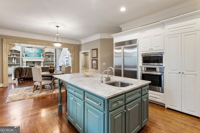 150 Inwood Ter, Roswell, GA 30075 - kitchen featuring decorative light fixtures, built in appliances, a sink, dark wood-style flooring, and crown molding