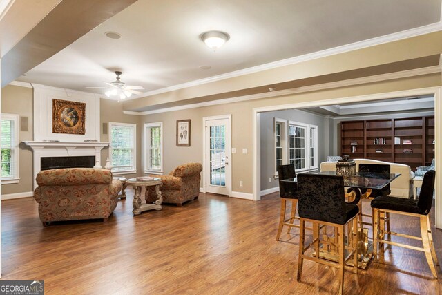 150 Inwood Ter, Roswell, GA 30075 - dining area featuring baseboards, ornamental molding, a ceiling fan, a high end fireplace, and wood finished floors