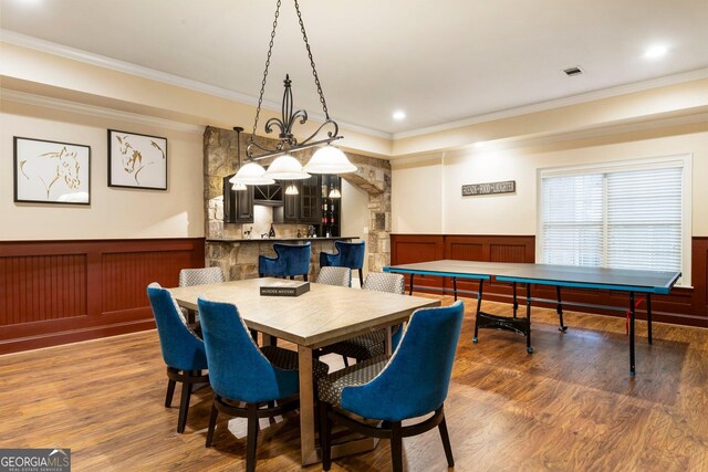 150 Inwood Ter, Roswell, GA 30075 - dining room featuring crown molding, a decorative wall, visible vents, a wainscoted wall, and wood finished floors