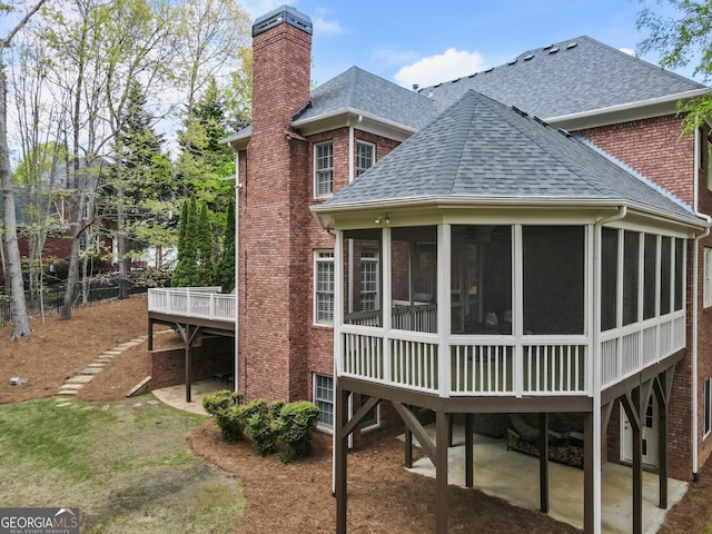 150 Inwood Ter, Roswell, GA 30075 - back of property with roof with shingles, a chimney, a patio area, brick siding, and a sunroom