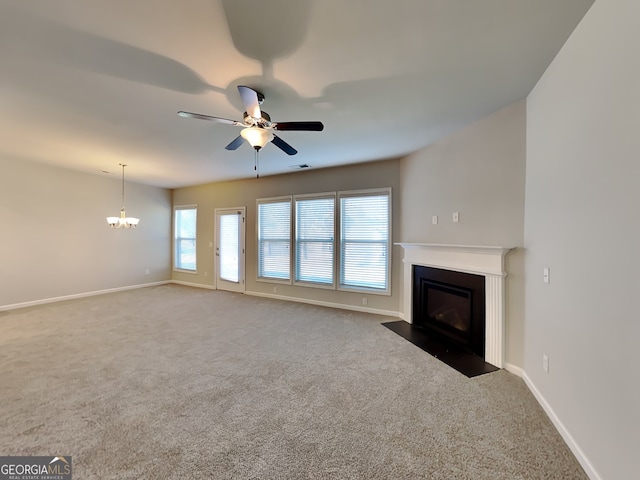 3713 Upland Dr, Mcdonough, GA 30253 - unfurnished living room featuring ceiling fan with notable chandelier, a fireplace with flush hearth, baseboards, carpet floors, and visible vents