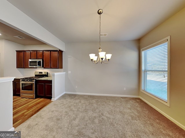 3713 Upland Dr, Mcdonough, GA 30253 - kitchen featuring baseboards, a chandelier, visible vents, light carpet, and appliances with stainless steel finishes