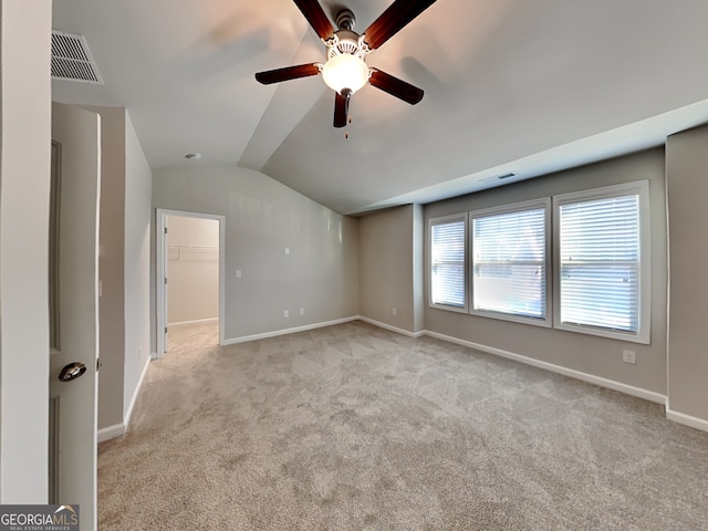 3713 Upland Dr, Mcdonough, GA 30253 - spare room featuring lofted ceiling, visible vents, a ceiling fan, and light colored carpet