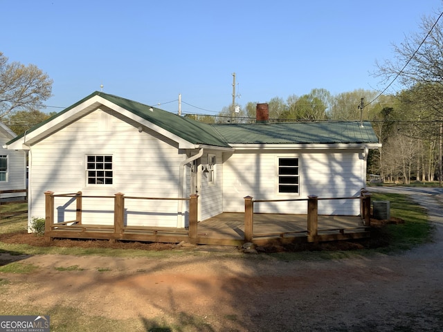 2790 Old Farmington Rd, Watkinsville, GA 30677 - back of house featuring a deck, a metal roof, and a chimney