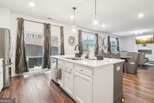 137 Park Chase Ln, Dallas, GA 30132 - kitchen with open floor plan, stainless steel appliances, dark wood finished floors, a sink, and visible vents