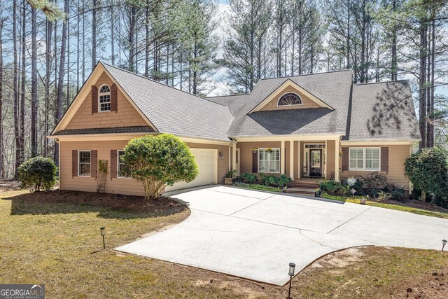 404 Golden Delicious Rd, Clarkesville, GA 30523 - view of front of house featuring a front lawn, concrete driveway, an attached garage, covered porch, and roof with shingles
