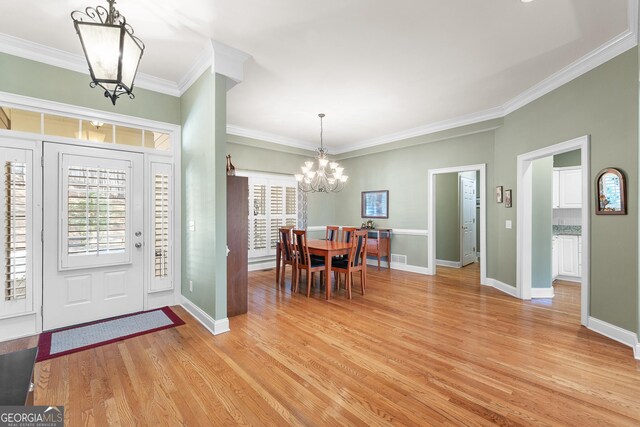 404 Golden Delicious Rd, Clarkesville, GA 30523 - foyer with light wood-type flooring, baseboards, an inviting chandelier, visible vents, and ornamental molding