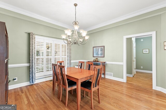 404 Golden Delicious Rd, Clarkesville, GA 30523 - dining area featuring a chandelier, light wood-style flooring, crown molding, and baseboards