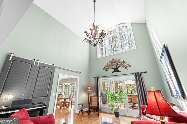 404 Golden Delicious Rd, Clarkesville, GA 30523 - living room with wood finished floors, high vaulted ceiling, and a chandelier