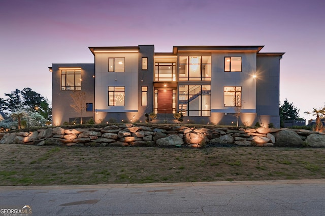 modern home with stucco siding and a balcony